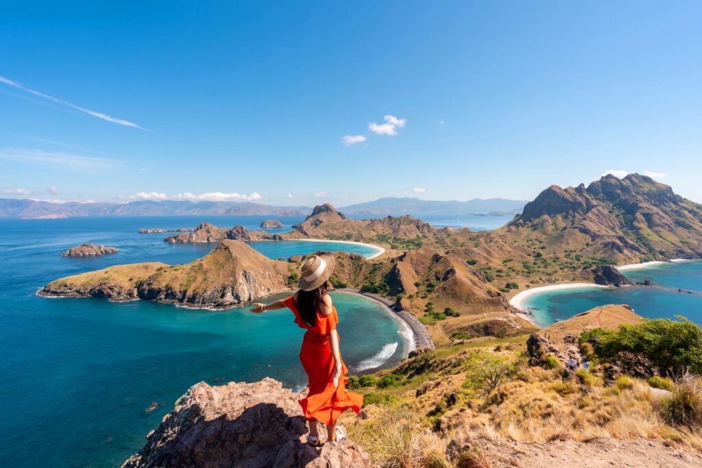 Panoramablick über mehrere geschwungenen Buchten und zerklüftete Hügelinseln, mit klarem Himmel und tiefblauem Meer in einer weitläufigen Landschaft.
