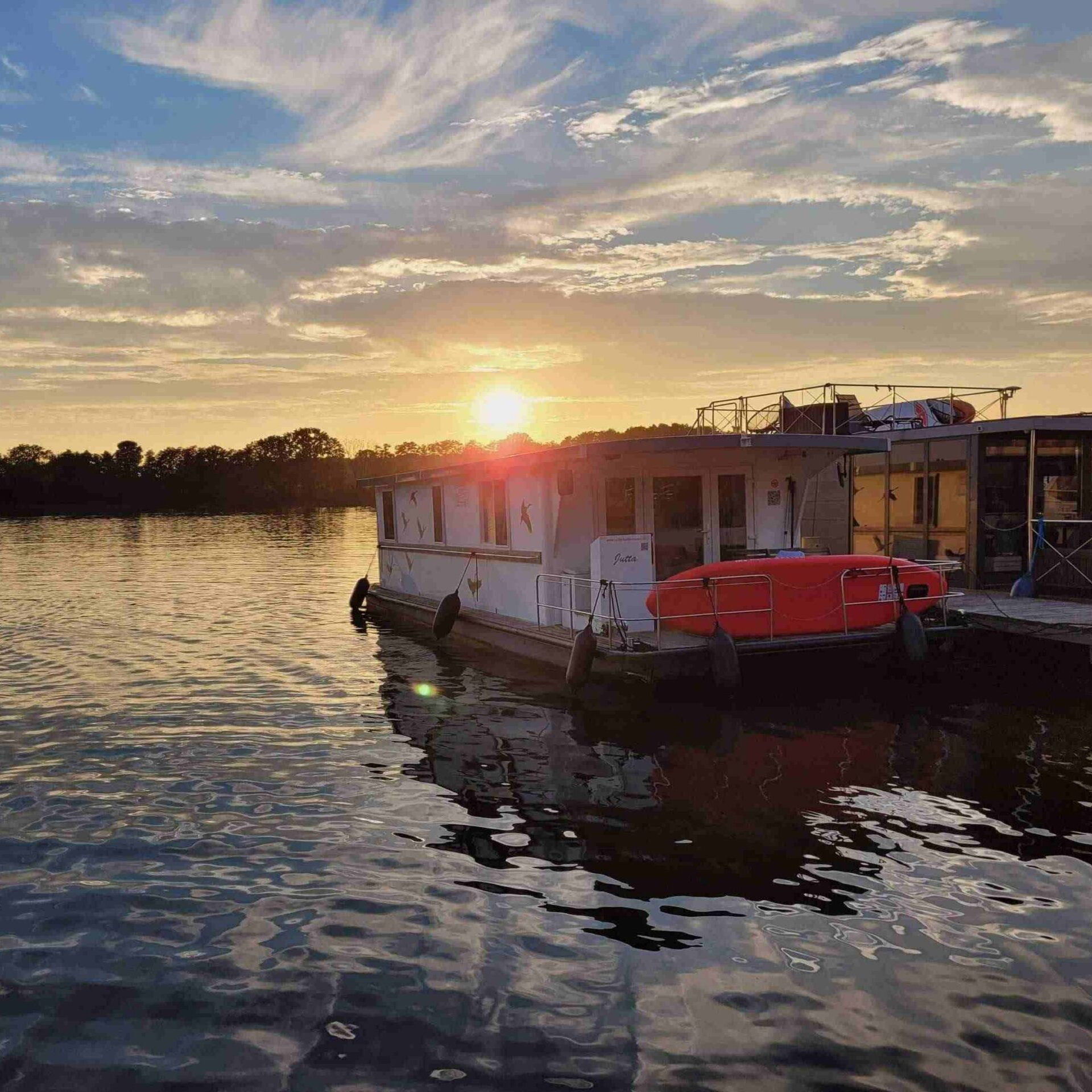 Houseboat on Mirower See at sunset, Mecklenburg lake district, Mecklenburg-Vorpommern, Germany