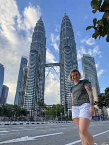 Weibliche Person in Malaysia vor den Petronas Twin Towers in Kuala Lumpur