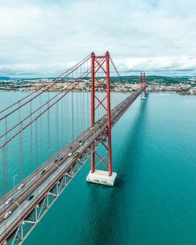 Panoramic photograph of the 25 de Abril bridge in the city of Lisbon over the Tajo River.